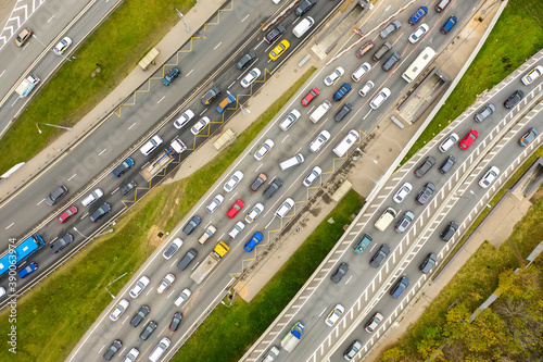 Aerial drone view of highway with busy urban traffic in modern city. Traffic jam from above