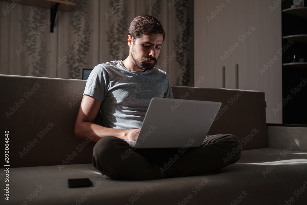 Remote Job. Man Working On Laptop Sitting On Sofa At Home. Remote Job. Man Working On Laptop Sitting On Sofa At Home.