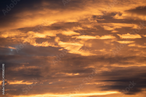 Dense grey clouds are partially colored reddish during a sunset, sky wallpapers © Iven O. Schlösser