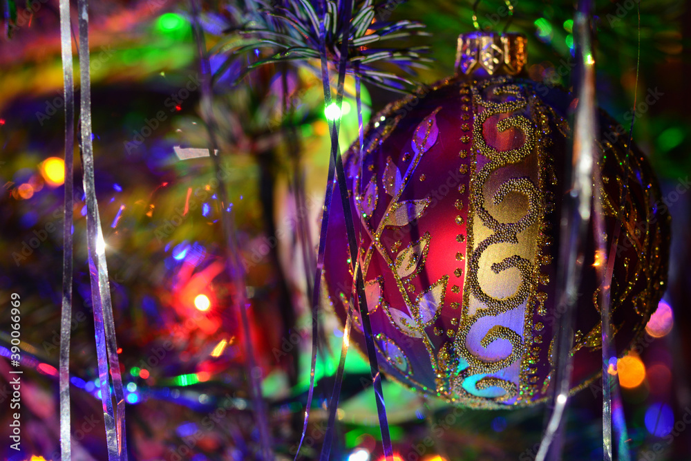 Christmas tree holiday background with glass balls, and lights. Colorful decoration close-up in low-key lighting. Christmas tree holiday background with glass balls, and lights. Colorful decoration close-up in low-key lighting.