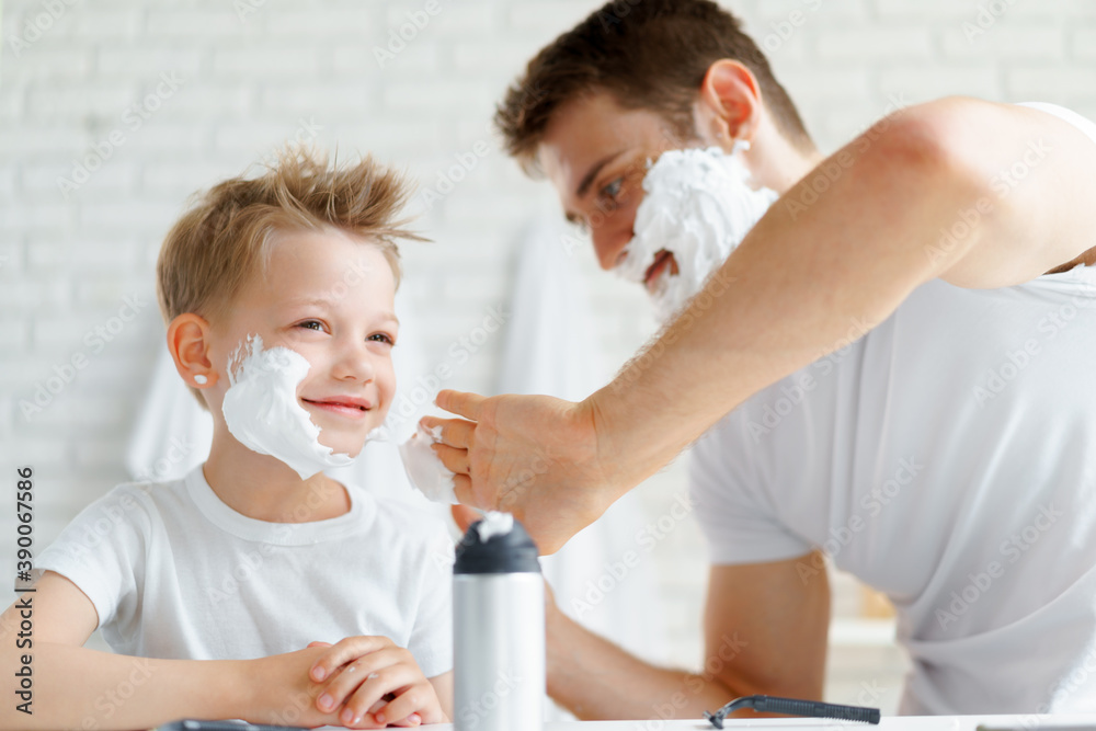 Father teaches his little son how to shave face