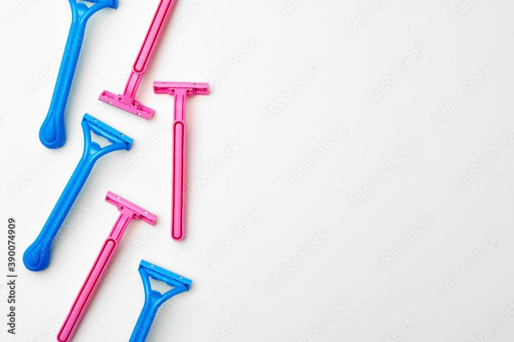 Pink and blue razors on white background Pink and blue razors on white background