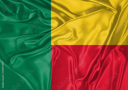Benin flag waving in the wind. National flag on satin cloth surface texture. Background for international concept.