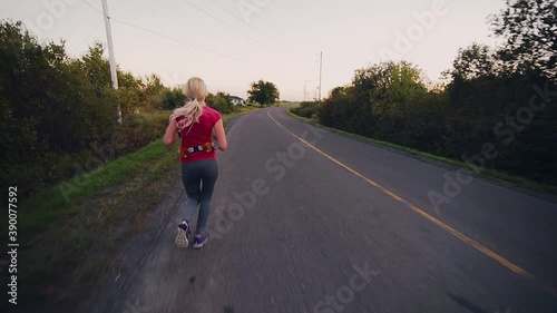Wallpaper Mural Side View of Woman Running for Long Distance Alone in the Street in a Beautiful Rural Place During Sunset. Torontodigital.ca