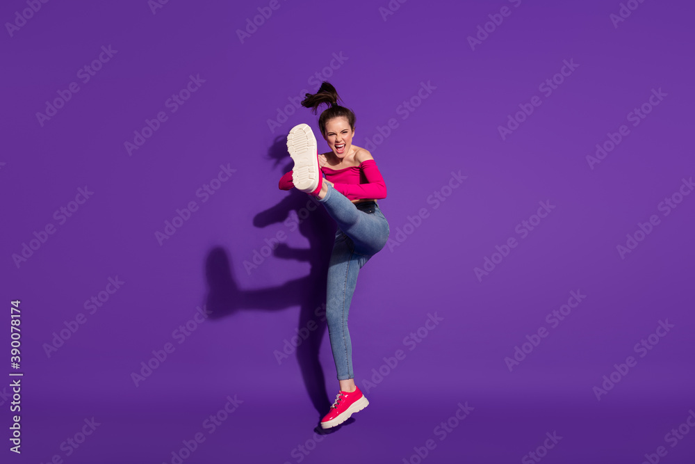 Full length body size view of strong cheerful girl fighting invisible enemy judo art isolated bright violet color background