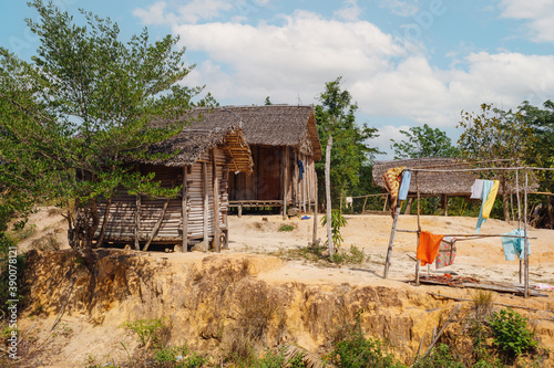 Traditional wooden african malagasy hut with roof from straw, typical village in north west Madagascar. Madagascar landscape. photo