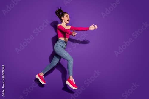 Full length body size view of kind slim cheerful girl jumping running hugging invisible people isolated bright violet color background