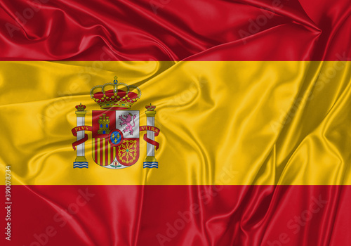 Spain flag waving in the wind. National flag on satin cloth surface texture. Background for international concept.