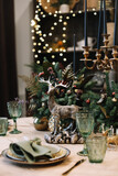 Festive table setting for Christmas dinner.  New Year holidays celebration decorations in modern interior design.