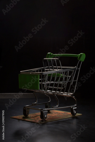 Metal trolley shopping cart, stands on an electronic Board.