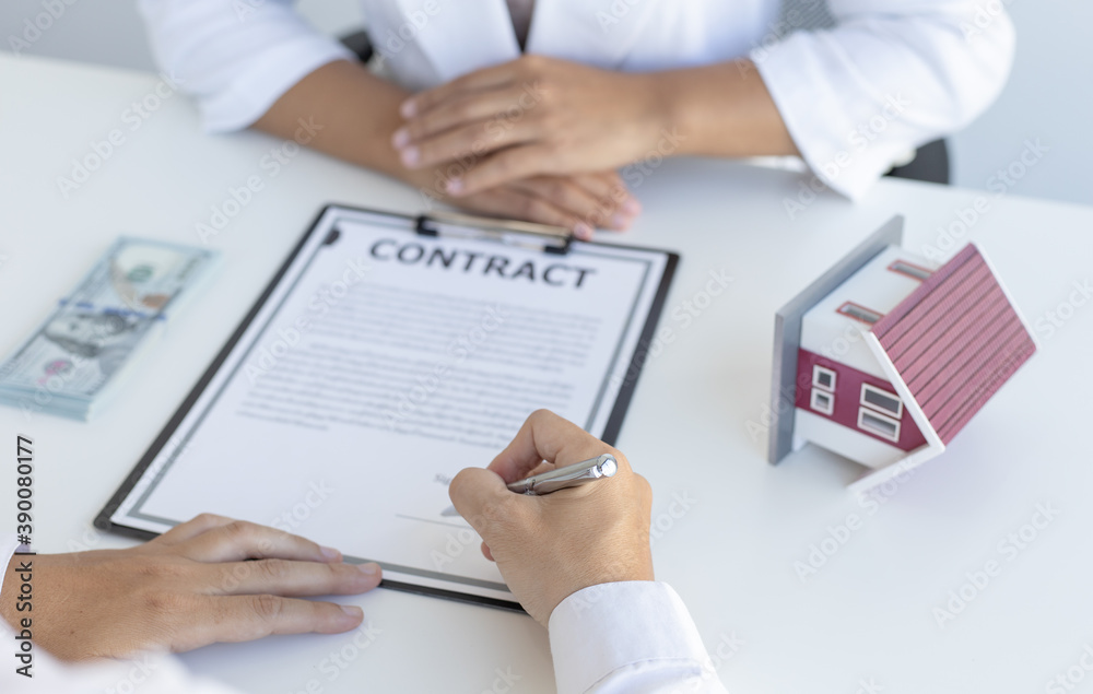 Home salesman explains the terms of buying a home to customers who need accommodation. Home salesman explains the terms of buying a home to customers who need accommodation.