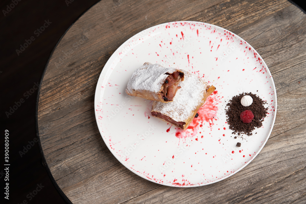 Fototapeta premium Strawberry biscuit roll with berry syrup and fromage frais