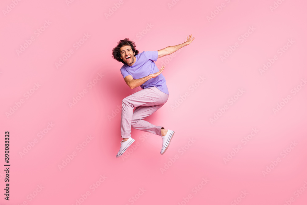 Full body photo of joyful active stylish brown haired bristled young man jump air happy sale isolated on shine pink color background