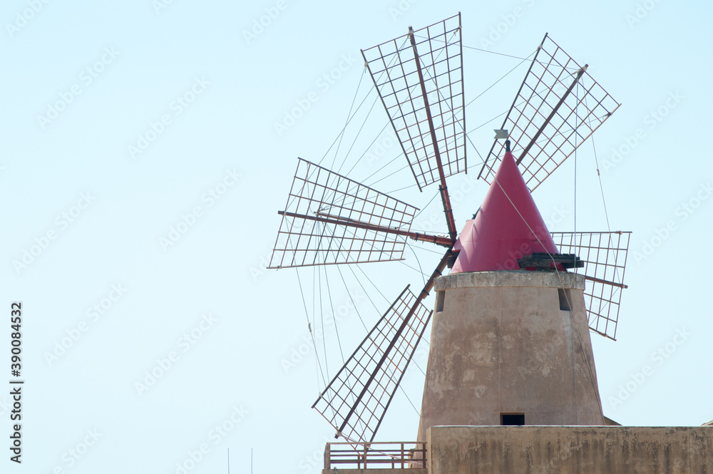 One of the many wind mill of the Trapani's salt pans with its characteristic red roof
