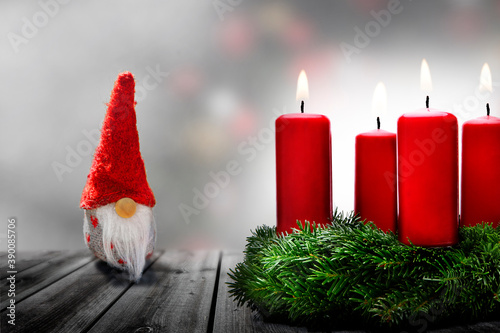 Kleiner Weihnachtsmann mit Adventskranz