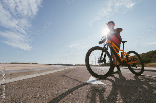 Rider crosses road with electric bike