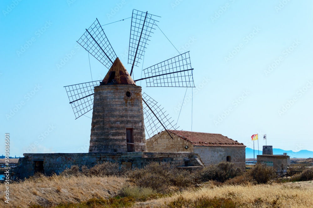 One of the many wind mill of the Trapani's salt pans with its characteristic red roof
