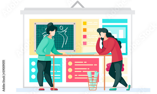 Colleagues in the atelier are discussing the model of the future pattern with the blackboard in the background. Girls draw a pattern for future clothes. Professional tailoring studio. Sewing a garment