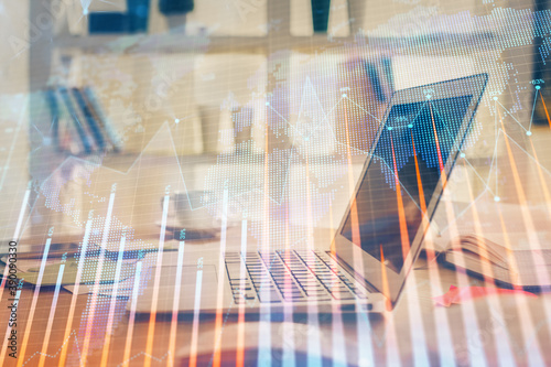 Financial chart drawing and table with computer on background. Double exposure. Concept of international markets.