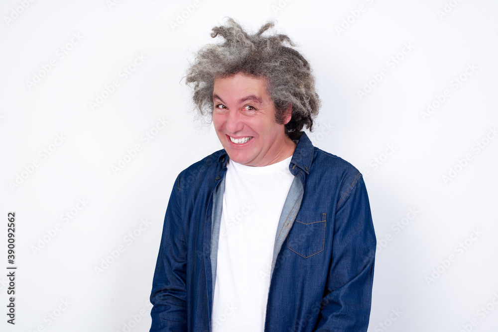 Oops! Portrait of Handsome middle aged Caucasian man with afro gray hair, against white wall, clenches teeth and looks confusedly aside, realizes her bad mistake, Oops! Portrait of Handsome middle aged Caucasian man with afro gray hair, against white wall, clenches teeth and looks confusedly aside, realizes her bad mistake,