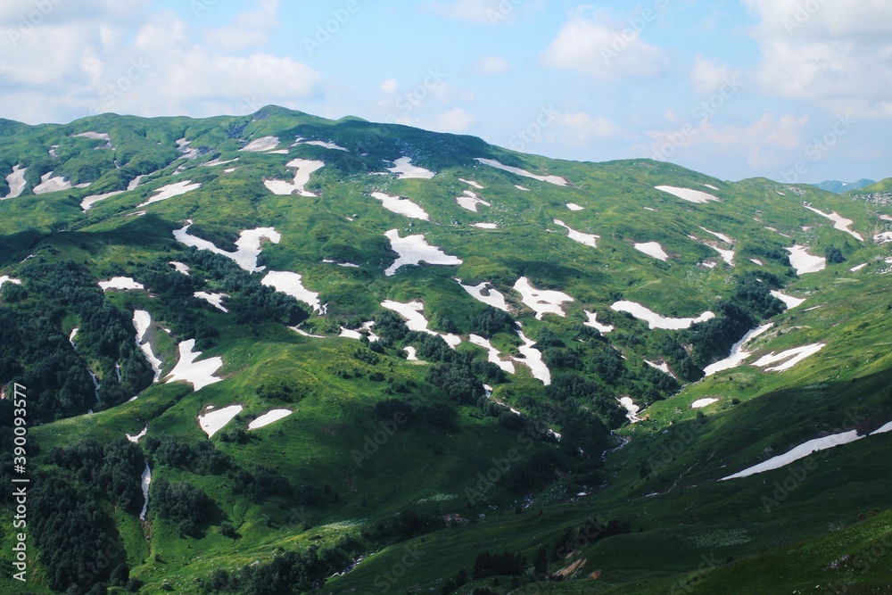 Green mountains and hills with snow. Caucasian reserve