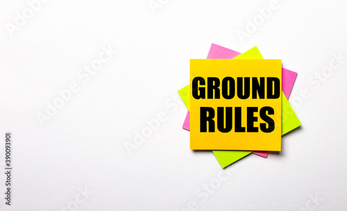 On a light background - bright multicolored stickers with the text GROUND RULES. Copy space