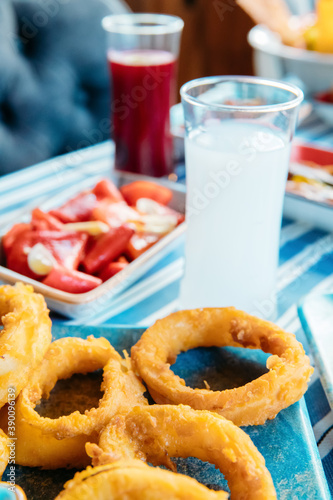 Photography Seafoods, grilled meat, meze, herbs, fish, raki, ouzo, appetizers and salads in Greek or Turkish Fish Restaurant on the table for dinner or lunch at the beach from Greece or Turkey