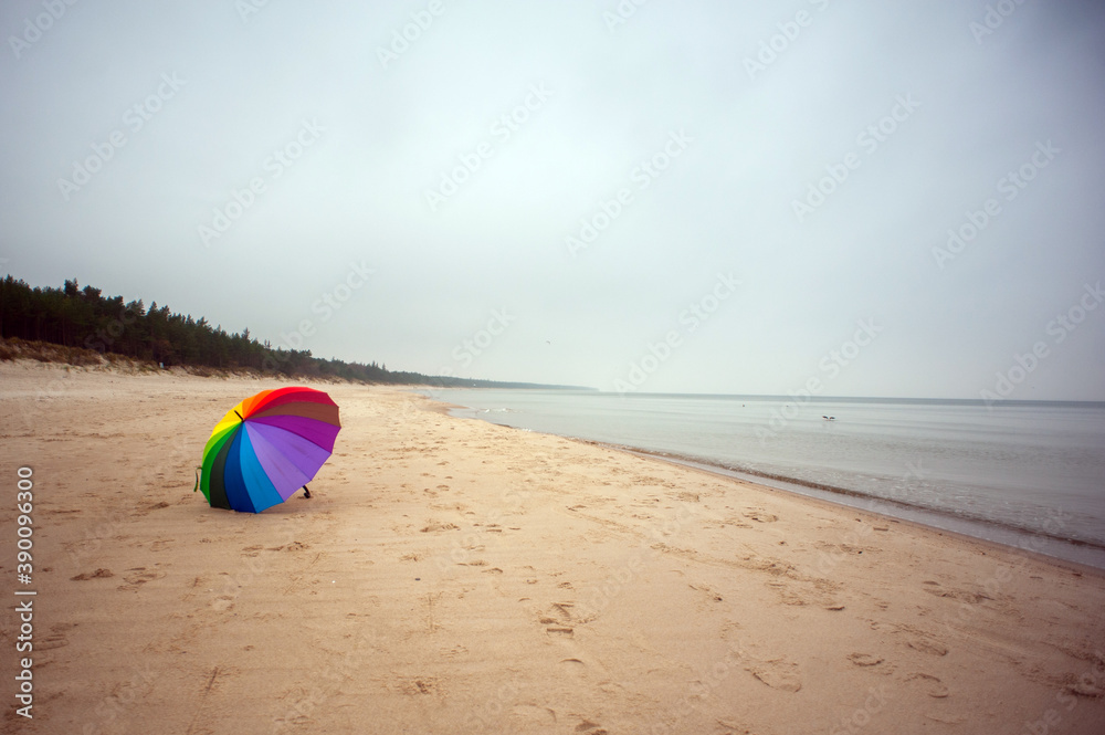 Obraz premium Rainbow umbrella on the beach