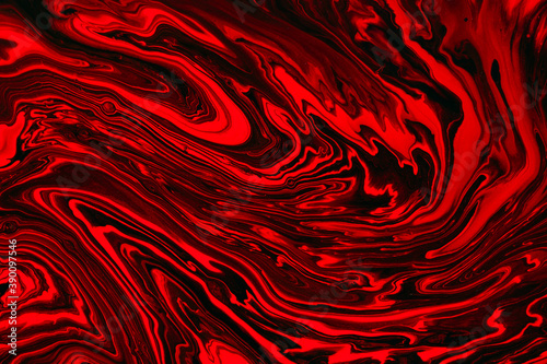 Fluid art texture. Abstract background with swirling paint effect. Liquid acrylic artwork with colorful mixed paints. Can be used for background or poster. Red, black and orange overflowing colors