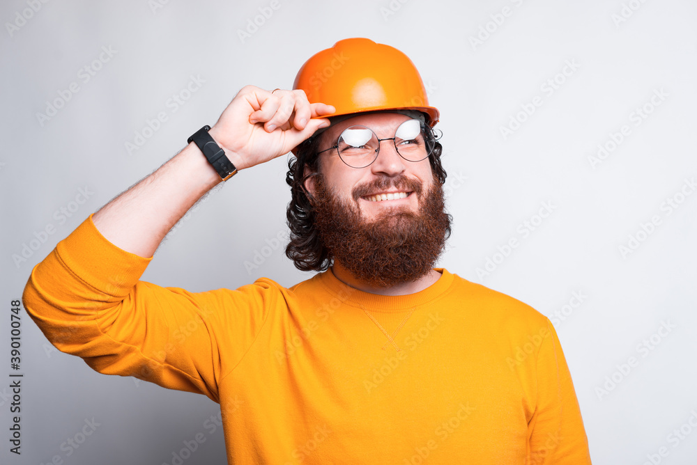 Portrait of cheerful young architect and wearing orange helmet. Portrait of cheerful young architect and wearing orange helmet.