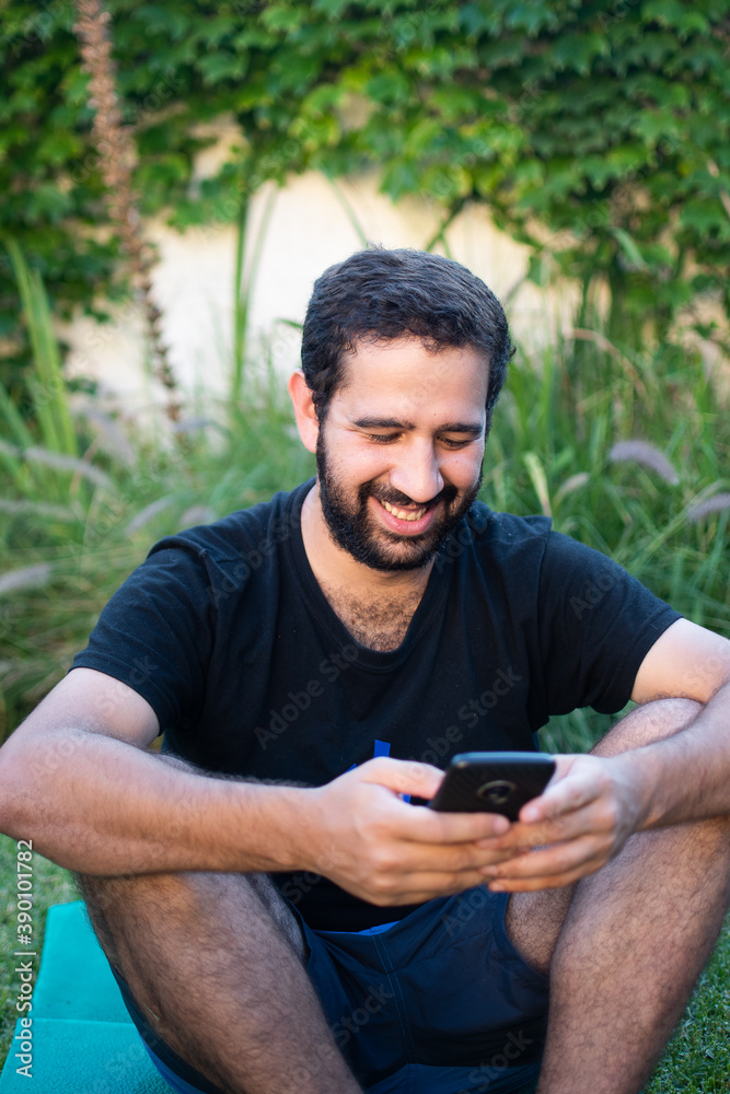 man smiling while texting with cell phone man smiling while texting with cell phone