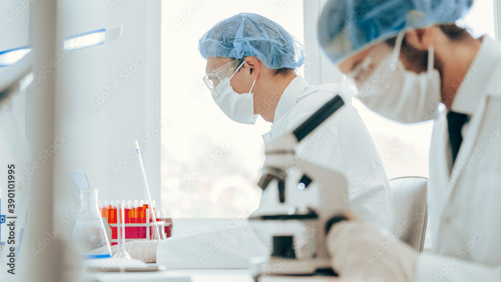 close up. scientist using a microscope in the laboratory. close up. scientist using a microscope in the laboratory.