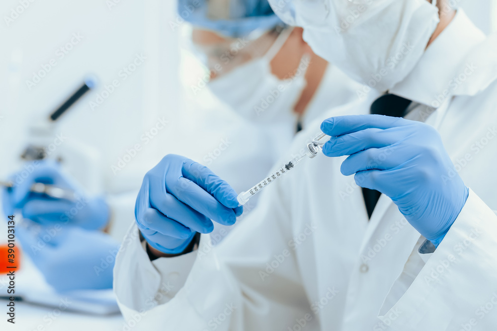 close up. group of scientists in protective clothing working in the laboratory. close up. group of scientists in protective clothing working in the laboratory.
