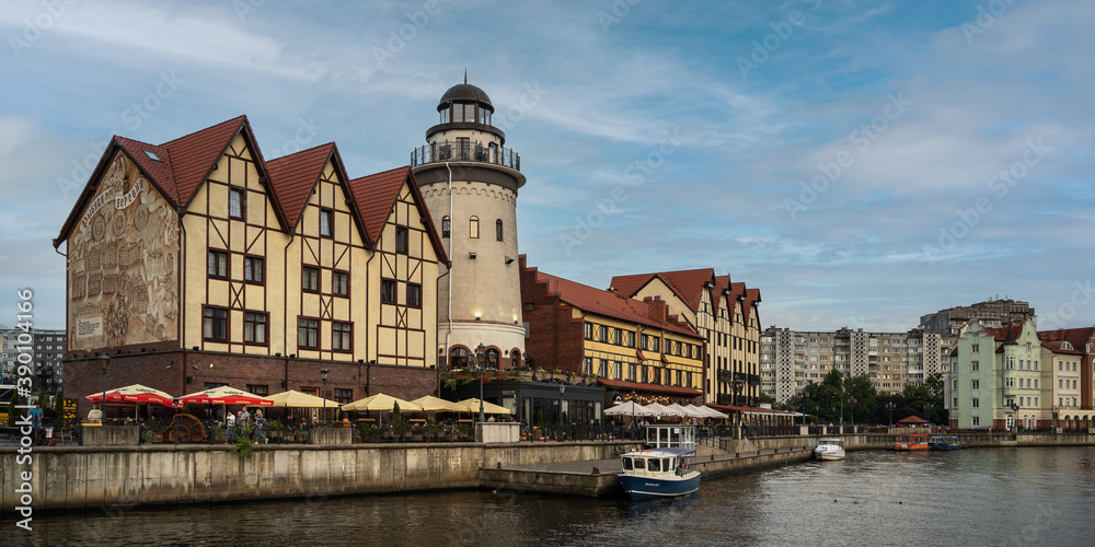 RUSSIA, KALININGRAD - SEPTEMBER 08, 2020: View of old famous place Buildings on Fishing Village in Kaliningrad, Russia against a blue sky with clouds. Outdoor, lighthouse