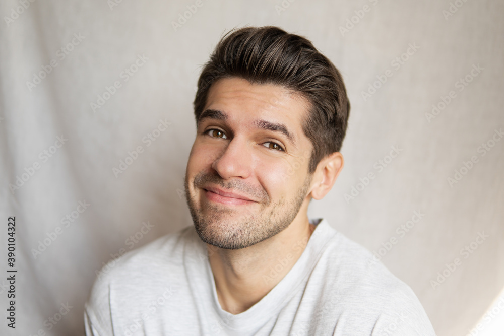 Portrait of a young handsome man with a super cute face expression looking in to the camera Portrait of a young handsome man with a super cute face expression looking in to the camera