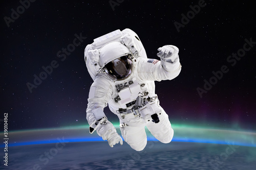 Fototapeta Naklejka Na Ścianę i Meble -  Composite image of astronaut floating in space, earth planet in the background -  Elements of this image are furnished by NASA