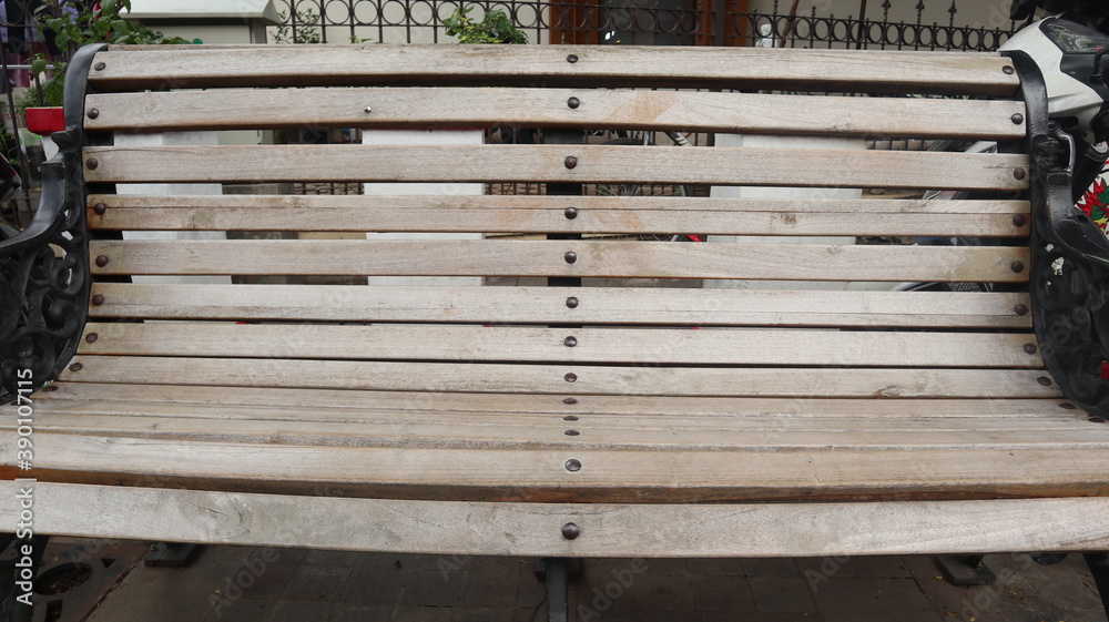 Selective and partial part image a retro style of garden bench with iron legs and armchair, photographed from above at close range Selective and partial part image a retro style of garden bench with iron legs and armchair, photographed from above at close range