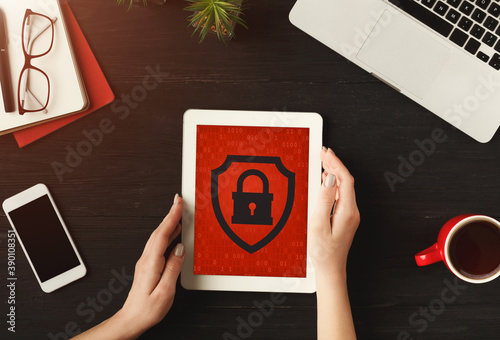 Business woman works on tablet with red screen and blocked website