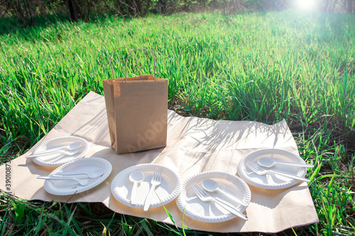 biodegradable corn starch cookware and craft picnic bag. eco friendly. spoons, forks, plates from environmentally friendly materials. modern replacement for plastic.