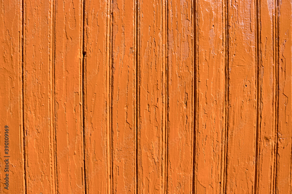 Old orange wood texture background. painted wooden wall. Orange background. Bright fence made of vertical boards