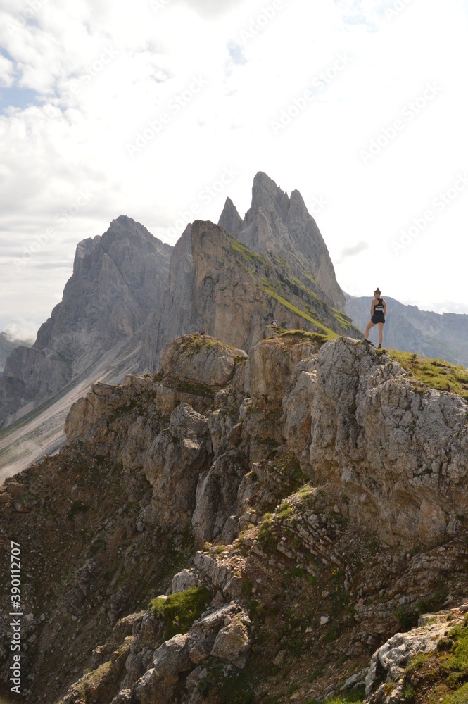 Naklejka premium Hiking on the dramatic mountain ridge of Seceda in South Tyrol's Dolomites, Northern Italy
