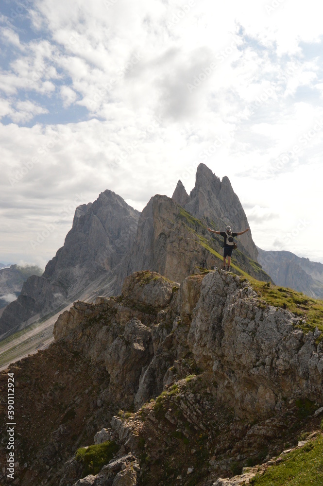 Obraz premium Hiking on the dramatic mountain ridge of Seceda in South Tyrol's Dolomites, Northern Italy