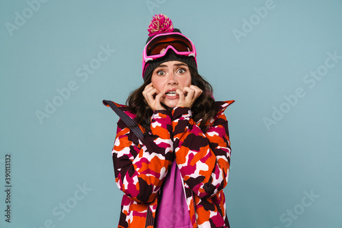 Puzzled woman wearing snowboard jacket isolated