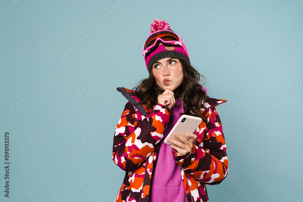 Excited beautiful sportswoman using cellphone isolated Excited beautiful sportswoman using cellphone isolated