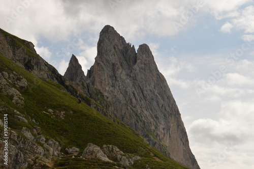 Hiking on the dramatic mountain ridge of Seceda in South Tyrol's Dolomites, Northern Italy