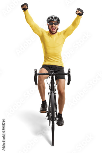 Male cyclist riding a road bicycle towards the camera and gesturing happiness