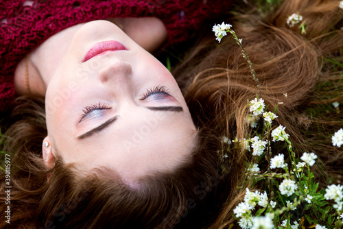 Woman with closed eyes dreaming and meditating in nature
 photo