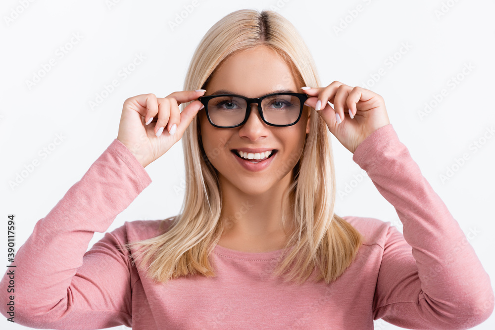 Blonde woman looking at camera while wearing eyeglasses isolated on white