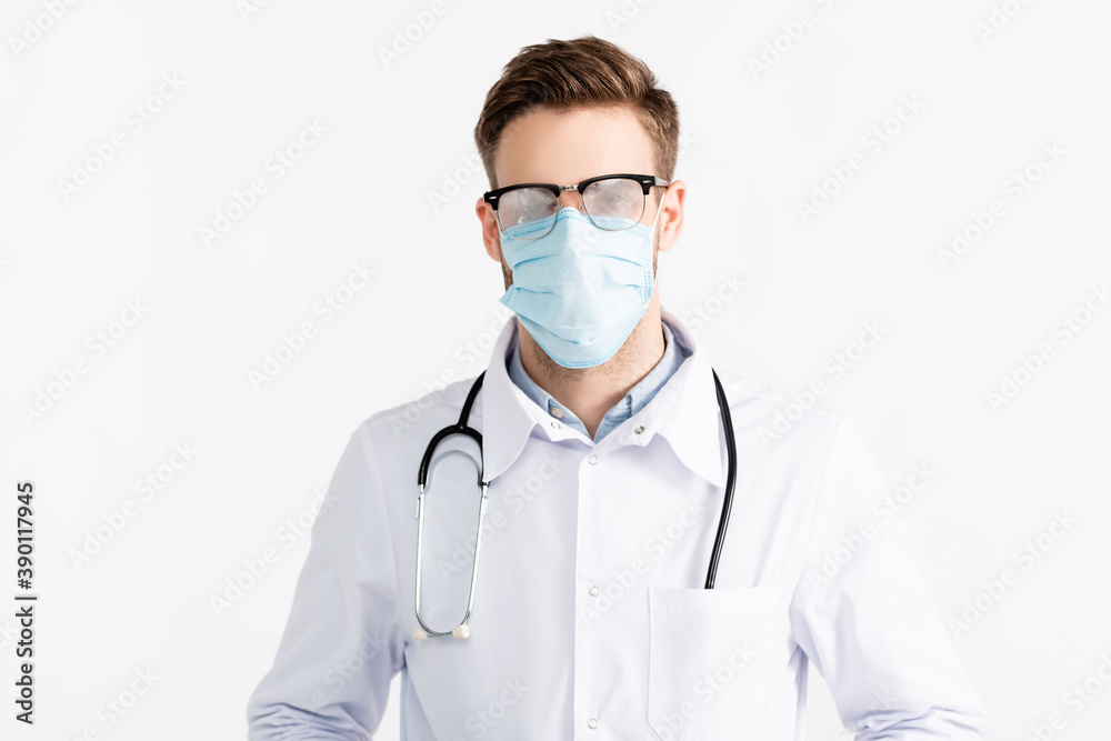 Front view of doctor with steamed eyeglasses and medical mask isolated on white