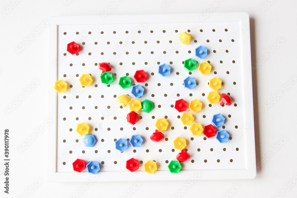 Board game, educational game. The mosaic is multicolored. A bright game for children. Educational logic game. A hobby, a pastime.